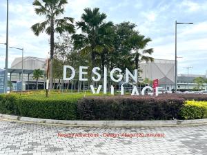 a sign in front of a building with palm trees at Home10perwira#6pax#netflix#simpangampat#neariconicpoint in Simpang Ampat