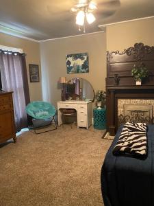a living room with a desk and a fireplace at Charming Wheeling Island Home in Wheeling