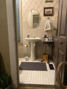a bathroom with a sink and a mirror at Charming Wheeling Island Home in Wheeling +39 photos