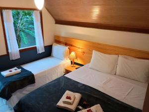 Cama ou camas em um quarto em Pousada dos Anjos