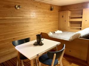 a room with a bed and a table and chairs at le sinagot in La Celle-sous-Gouzon