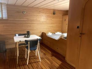 a room with a bed and a desk and a table at le sinagot in La Celle-sous-Gouzon