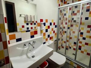 a bathroom with a sink and a toilet and a shower at Casa Rural Aracena Bliss in Aracena