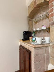 a kitchen with a counter with bowls on it at PienzaLettings Studio & Room in Pienza +51 photos