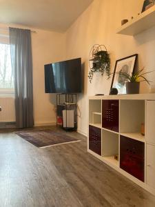 a living room with a flat screen tv on the wall at Ferienwohnung Beta in Essen
