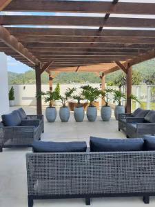 a patio with a bunch of chairs and plants at Loft vista Mar - Entre Itajaí e Balneário Camboriú in Itajaí
