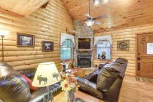 a living room with leather furniture in a log cabin at Backyard and Porch Rural Cosby Log Cabin! in Cosby