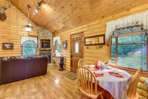 a dining room with a table in a cabin at Backyard and Porch Rural Cosby Log Cabin! in Cosby