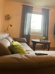 a living room with a couch and a window at Ferienwohnung Beta in Essen +2 photos