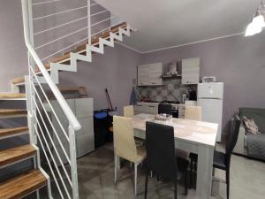 a kitchen and dining room with a table and a staircase at Casa Luisa casa vacanze in Civita Castellana