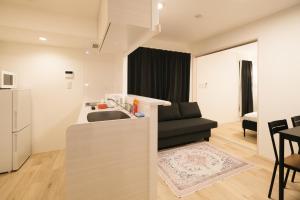 a kitchen with a sink and a black couch at Apb 两国 in Tokyo +88 photos