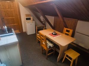 a small kitchen with a wooden table and chairs at Privat U Milana Hlavná 316 in Ždiar