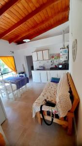 a bedroom with a bed in a room with a kitchen at Descanso en la Patagonia in Trelew