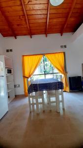 a dining room with a table and a window at Descanso en la Patagonia in Trelew +11 photos