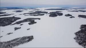 an aerial view of an island in the snow at Inari lake modest cabin in Inari