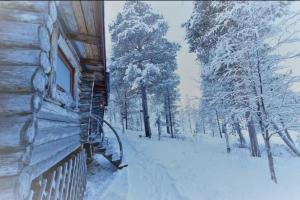 a log cabin in the snow with trees at Inari lake modest cabin in Inari