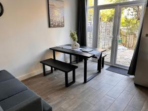 a living room with a table and a couch at Park Street Accomodation, Room 3 in Luton