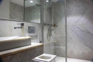 a bathroom with a shower and a toilet and a sink at Atelier Loft Oliver Palm Resort in Marrakesh +21 photos