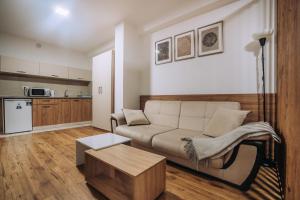 a living room with a couch and a table at SANA Apartments in Ohrid
