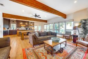 a living room with a couch and a table at Modern Fischer House with Deck, Fire Pit and Hot Tub! in Fischer