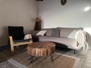a living room with a couch and a coffee table at Alma de Villuercas CR-CC-0070 in Cabañas del Castillo