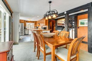 a kitchen and dining room with a wooden table and chairs at 11 Mi to Sugarbush Eclectic Ski House with Hot Tub! in Roxbury