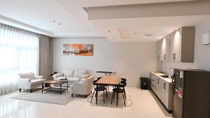 a kitchen and living room with a table and chairs at فندق نوفا ليس للخدمات الفندقيه in Najran