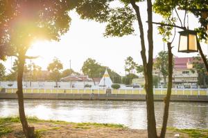 a view of a river with a bridge and a building at March Hotel & Suite Riverside in Chiang Mai
