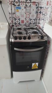 a stove top oven sitting inside of a refrigerator at Apt Mário Covas COP 30 in Belém