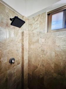 a bathroom with a shower with a window at Departamento 01 en el Centro de Holbox in Holbox Island +23 photos