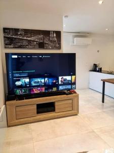 a large flat screen tv in a living room at LOasis Dijonnaise 8 PEOPLE in Sennecey-lès-Dijon