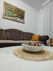a bowl of food on a table in a living room at Stan na dan Sunce in Bijeljina