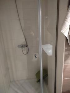 a shower with a glass door next to a sink at DORA'S APARTMENTS STUDIO 1 in Corfu Town +35 photos