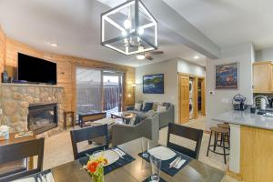 een keuken en een woonkamer met een open haard bij Patio and Mountain Views Central Grand Lake Condo! in Grand Lake