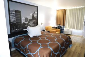 a hotel room with a bed and a large window at Super 8 by Wyndham Florence SC I-95 North - Hwy 76 in Florence