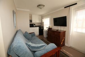 a living room with a couch and a flat screen tv at Bijou Bungalow in Beaufort