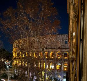 a large building at night with lights on at Colosseum's Custodian - Apartment 115 m2 in Rome