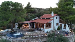a small white house with a red roof at Villa Haris in Sarti