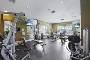 a gym with several treadmills and machines in it at Spacious 2BR Lely Resort Condo with Lake View steps to Pool Hot Tub Gym in Naples