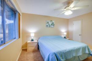 a bedroom with a blue bed and a window at Patio and Yard Sun City Home Near Casinos in Sun City