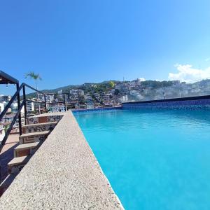 uma grande massa de água com uma cidade ao fundo em Luxo Studio Facing the Sea em Puerto Vallarta