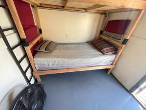a bunk bed in a small room with a fan at Vacaciones2023 in Mar del Plata