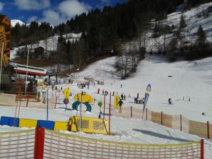 a group of people skiing down a snow covered slope at Paul-S Apartman in Bad Hofgastein