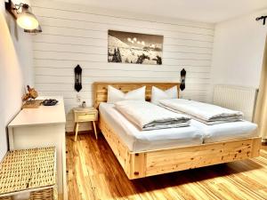 a bedroom with a wooden bed in a room at Sweet Home Apartments in Tösens