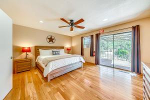 a bedroom with a bed and a ceiling fan at Spacious Ruidoso Home with Patio and Mountain Views! in Ruidoso