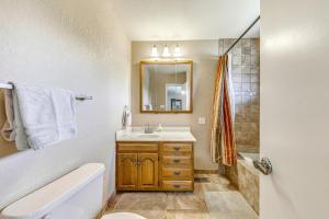 a bathroom with a sink and a toilet and a mirror at Spacious Ruidoso Home with Patio and Mountain Views! in Ruidoso +37 photos