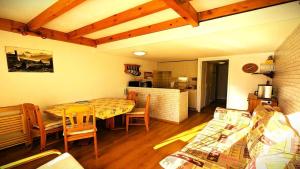 a room with a table and chairs and a kitchen at Résidence Les Anémones - Grand appartement T3, ensoleillé, avec balcon, pour 6 personnes MAE-6911 in Vallouise