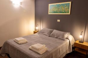 a bedroom with a bed with two towels on it at Hotel W in Neuquén