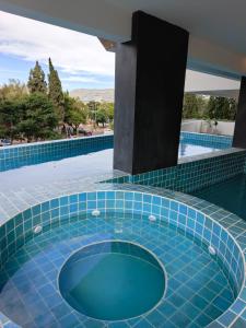 a swimming pool with a blue tiled floor at Hermoso depto in Tarija