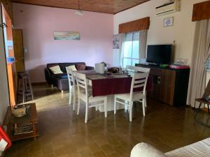a kitchen and living room with a table and chairs at Departamento 2 ambientes 1er piso in Gualeguay +10 photos